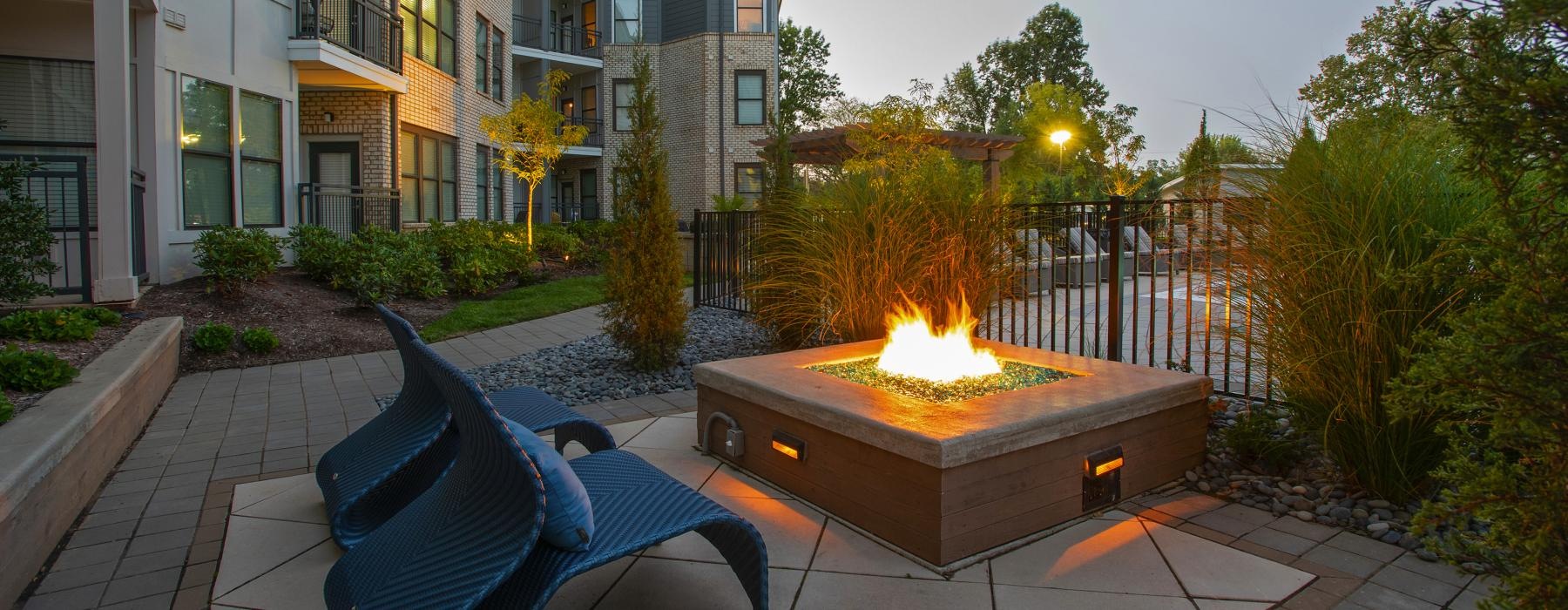 an outdoor patio with a fire pit and seating