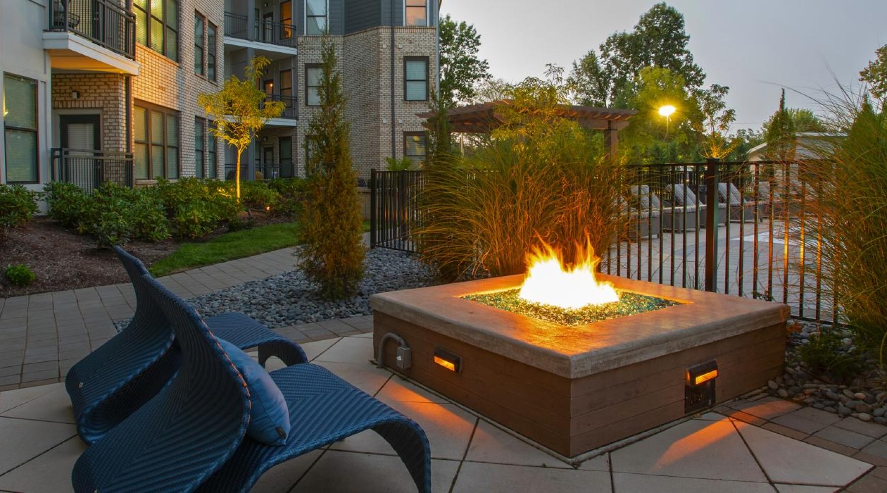 an outdoor patio with a fire pit and seating
